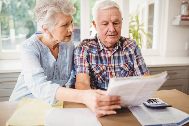 a senior couple reviewing paperwork for social security FRA
