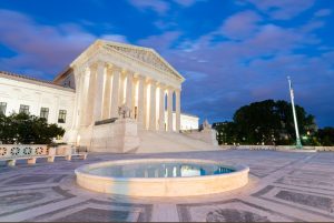 United States Supreme Court Building in Washington, DC, USA at night.