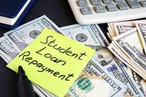 Money for Student Loan Repayment on the table.