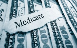 Medicare bills. Medicare paper headline on hundred dollar bills