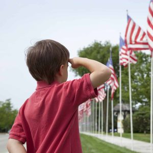 Child saluting a flag