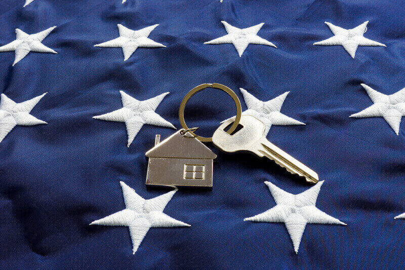 USA flag and the key from home as symbol of VA loan.