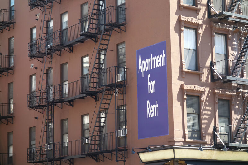 An Apartment for Rent sign on a New York City building.