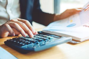 economic uncertainty, man doing his finances