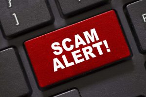 Scam Alert word on keyboard. Beware of scammers