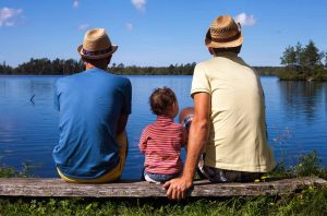 Three generations of man sitting on a bench