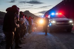 Migrants from Mexico and Guatemala are apprehended by U.S. Customs and Border Patrol officers after crossing a section of border wall into the U.S. on January 04, 2025 in Ruby, Arizona.
