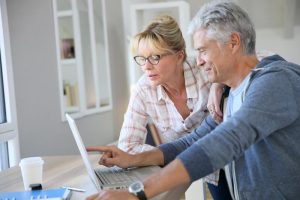 older couple planning on laptop retirement savings