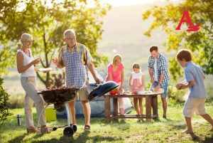 Happy family camping and cooking bbq