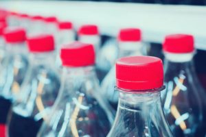 Soft drinks bottles on shelves in supermarket store