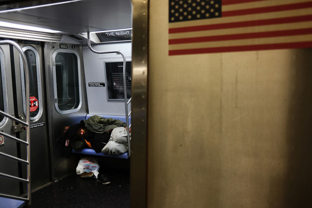 People sleep on a train car as the New York City subway system, the largest public transportation system in the nation, closes for nightly cleaning due to the continued spread of the coronavirus on May 07, 2020 in New York City.