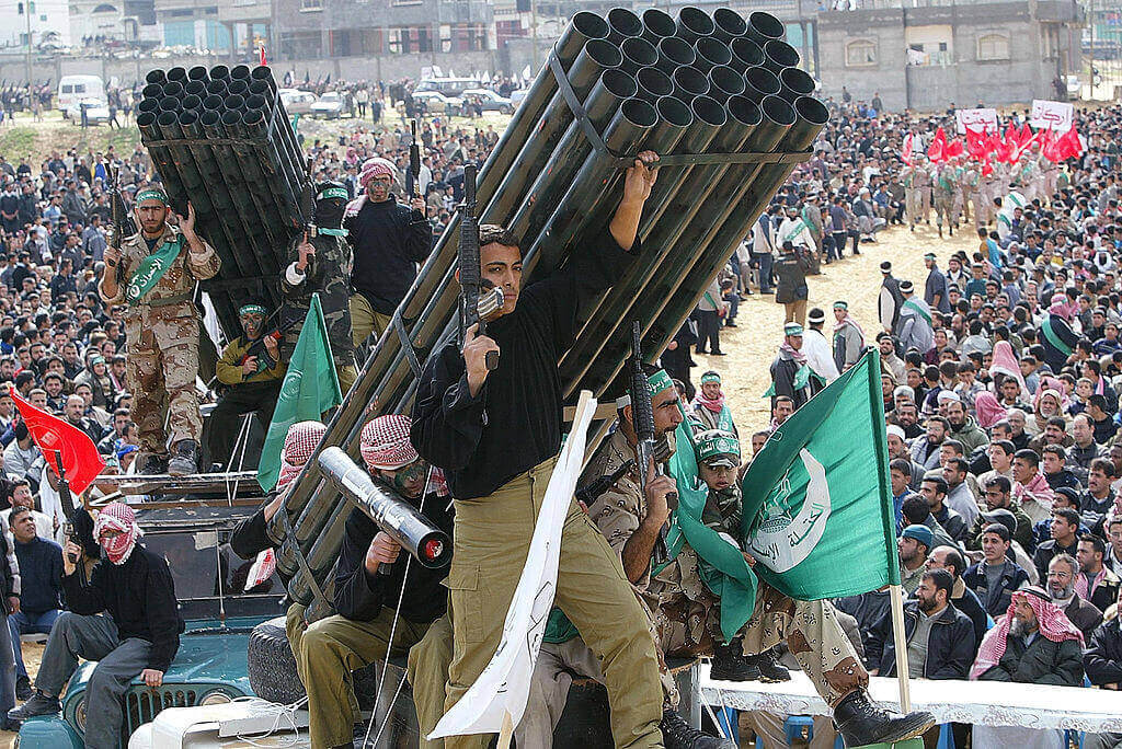 Hamas members display mock weapons as they attend a rally February 14, 2003 in Jabalyea refugee camp, north of Gaza Strip. Hamas is marking 53 years since the death of the Muslim Brotherhood founder Hassan Al-Banna. Approximately 10,000 Palestinians attended the rally, including Hamas leader Sheik Ahmed Yassin.
