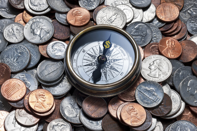 Compass Money Finance Management Services. A compass with a dollar sign where N should be, on an American coins background