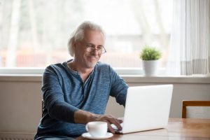 senior man using email on laptop