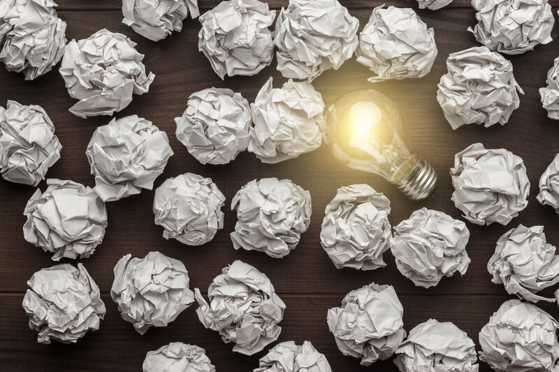New idea concept with crumpled office paper and light bulb