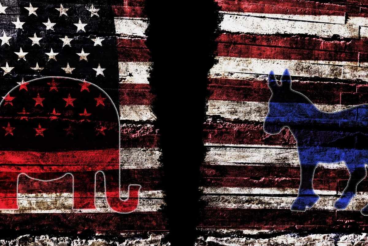 Torn American flag with Democrat and Republican party symbols representing division in US politics