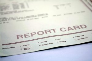 Report Card for Student or Teacher. Report card form for student. Grades and evaluations for high school or college student. Report card document on background.
