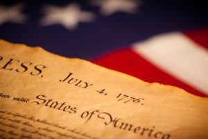 Declaration of Independence on flag background. United States Declaration of Independence on a Betsy Ross flag background