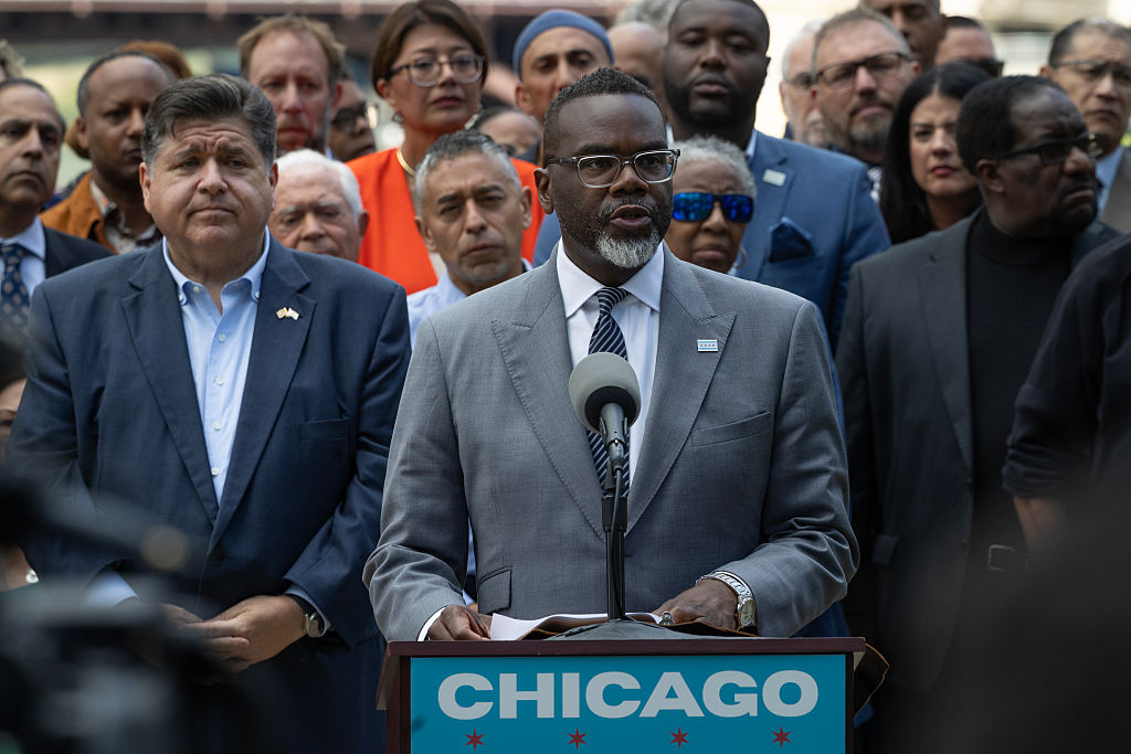 Flanked by Illinois Gov. JB Pritzker (L) and other Illinois politicians and community leaders, Chicago Mayor Brandon Johnson speaks at a news conference to address President Donald Trump's plan to send National Guard troops into the city on August 25, 2025 in Chicago, Illinois.