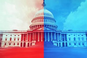 The US Capitol, split in red and blue, symbolizes the political party divide. A stylized split illustration of the US Capitol: the left half is red and the right blue, symbolizing Republican and Democratic parties, with colors bleeding into a hazy background. AI generated