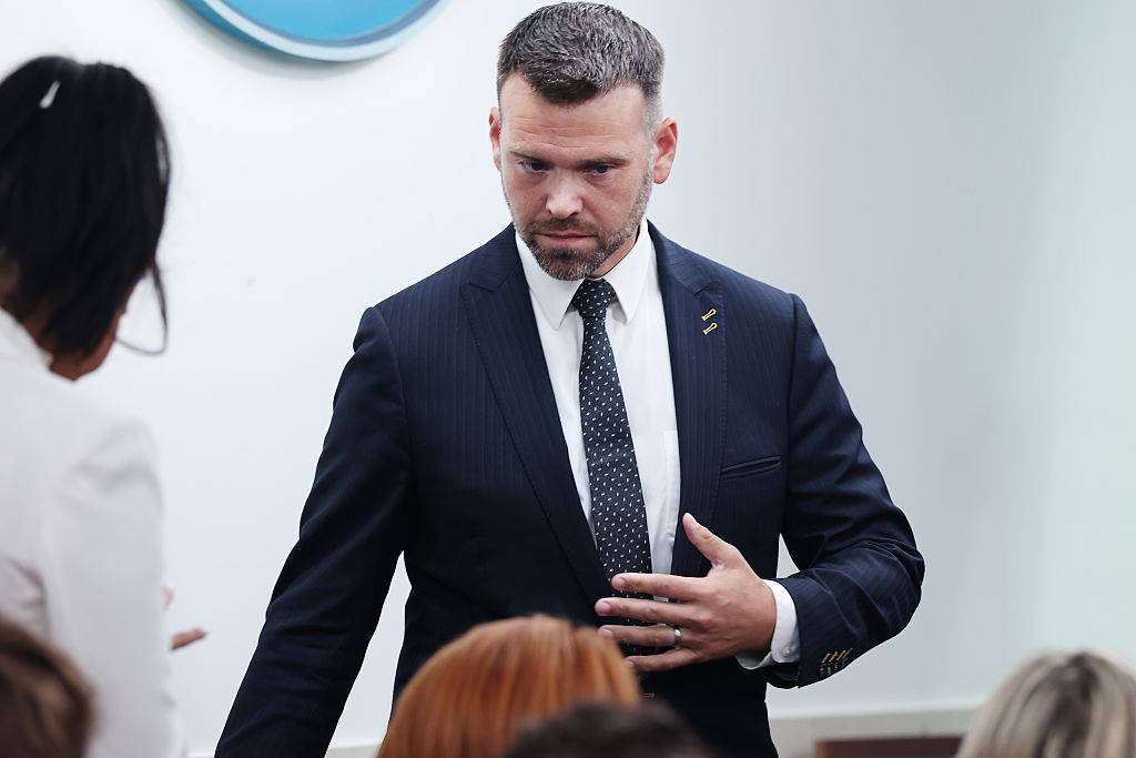 Conservative political activist and host of Human Events Jack Posobiec arrives to sit in the "New Media" seat at a press briefing in the Brady Press Briefing Room at the White House on August 19, 2025 in Washington, DC.