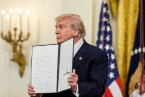President Donald Trump signs a proclamation affirming National Purple Heart Day in the East Room, Thursday, August 7, 2025.
