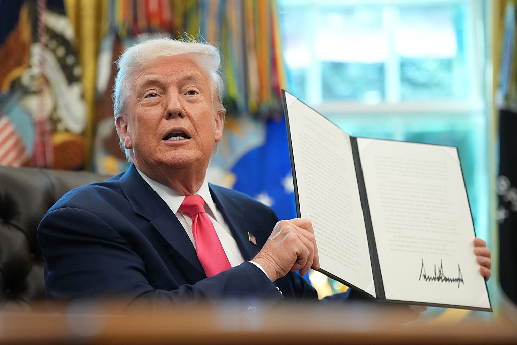 President Donald Trump holds up a proclamation with his signature in the Oval Office on August 14, 2025 in Washington, DC. Trump signed the proclamation on the 90th anniversary of Social Security
