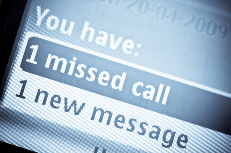Close up of a cell phone noting missed call and voice mail.