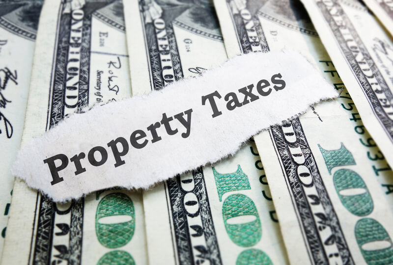 Property Taxes money. Property Taxes paper message on assorted money