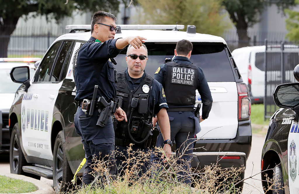 Dallas Police investigate the scene where a shooter opened fire on a U.S. Immigration and Customs Enforcement facility (ICE)