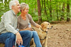 couple with pet in the woods