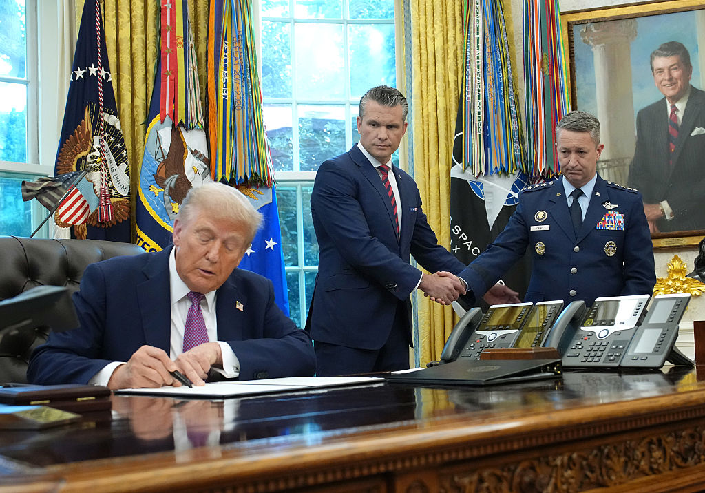 President Donald Trump signs an executive order renaming the Department of Defense as the Department of War