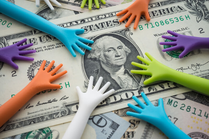 Many hand people borrow money, loan, credit from banking or government on US dollar bill banknotes background. Borrowing or begging money, business and financial concept.