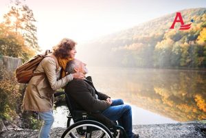 Senior couple sitting beside a lake in the fall