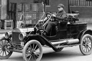 Young boy driving a Ford Model T in 1908