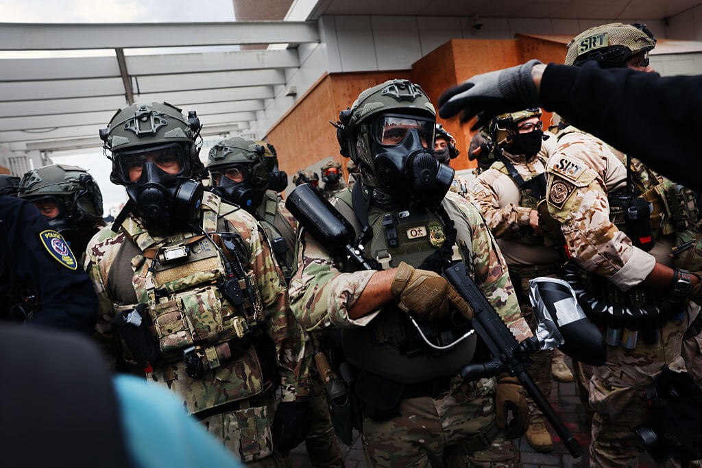 Federal agents, including members of the Department of Homeland Security, the Border Patrol, and police, attempt to keep protesters back outside a downtown U.S. Immigration and Customs Enforcement (ICE) facility on October 04, 2025 in Portland, Oregon.