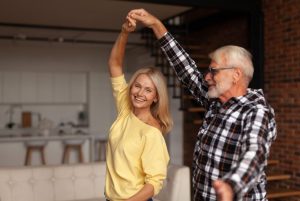happy older couple dancing, brain health movement