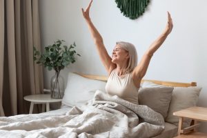women waking up in bed, sleep health