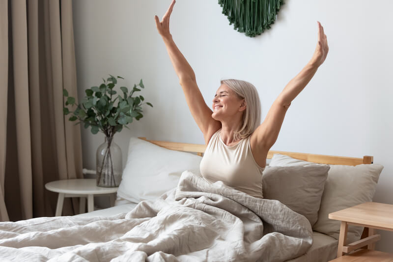 women waking up in bed, sleep health