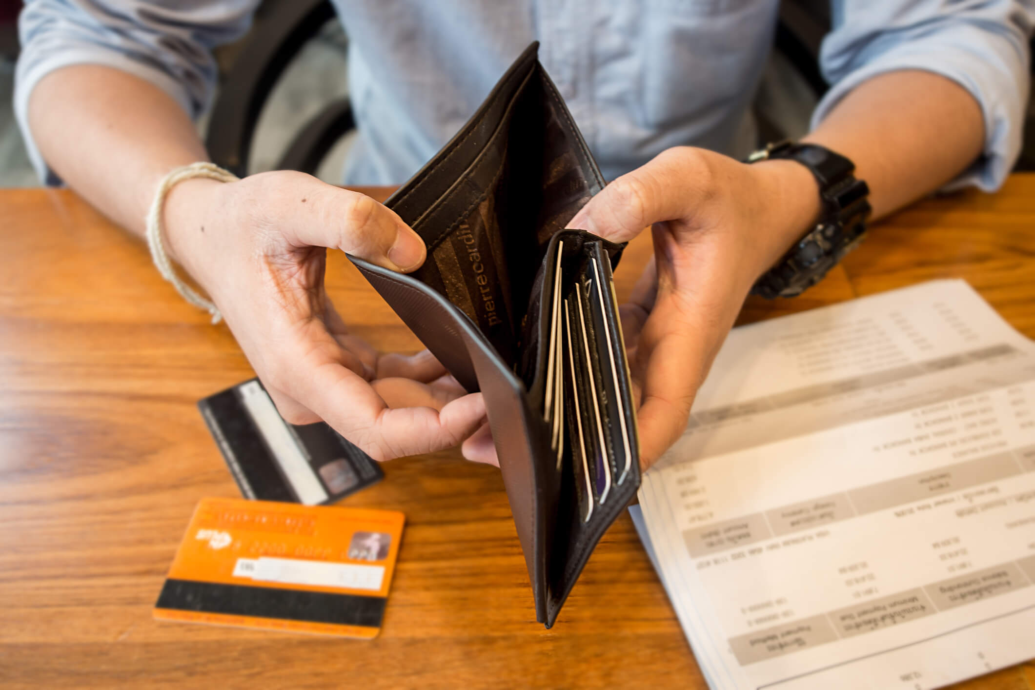 Credit card debt - holding an empty wallet.