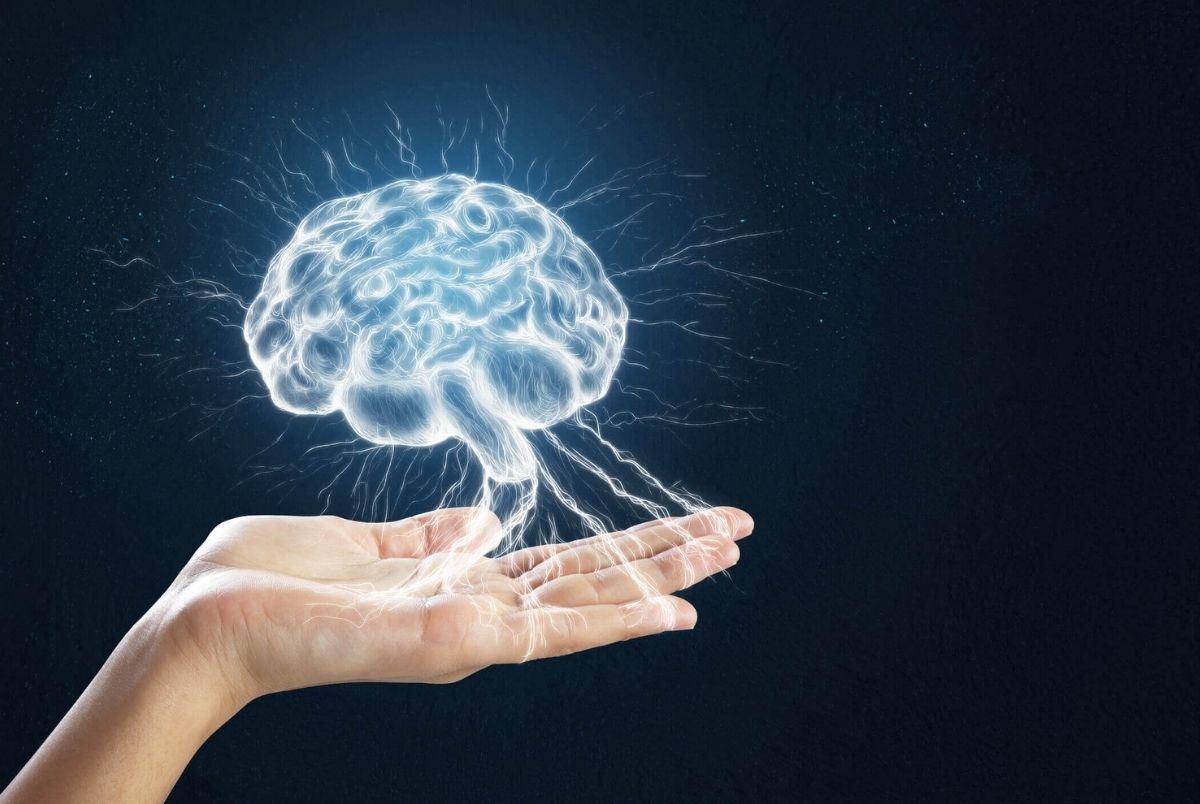 Hand holding digital brain on blue background. Science concept