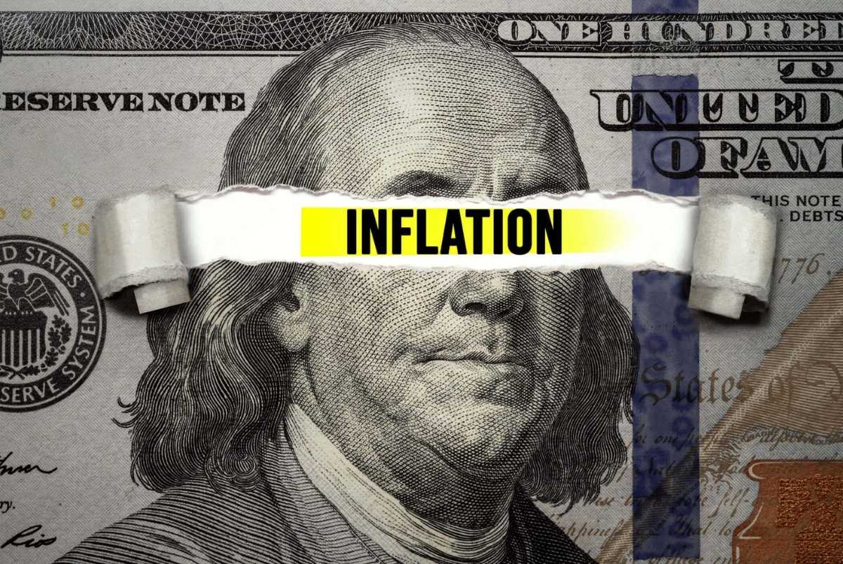 Torn bills revealing Inflation words. Idea for FED consider interest rate hike, world economics and inflation control, US dollar inflation