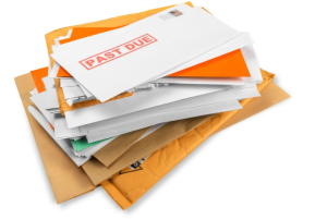 Pile of envelopes with overdue medical bills. Short-term medical insurance.