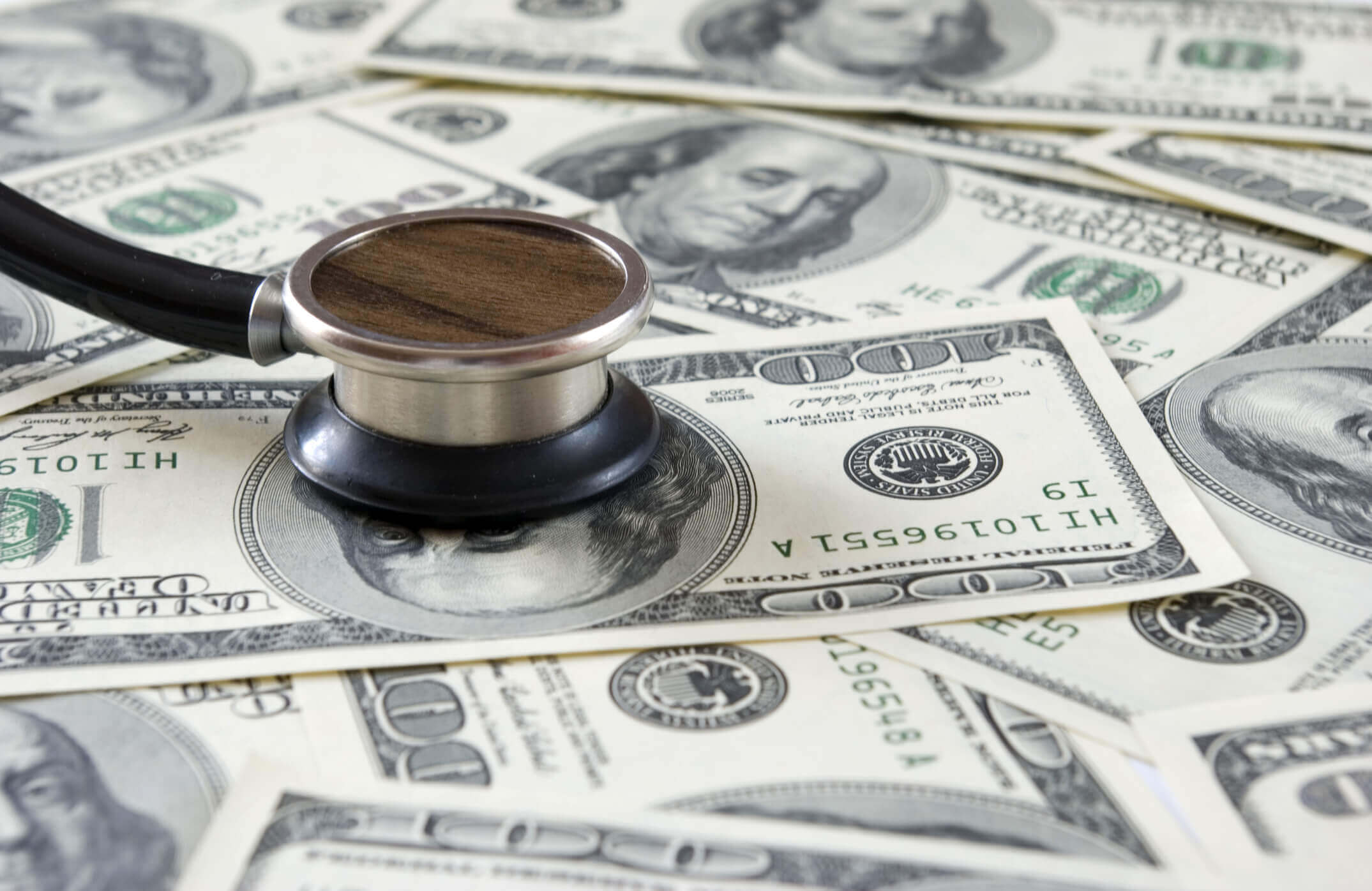 Stethoscope on money background of dollars
