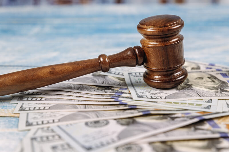 Court gavel and money on blue background. Court wooden gavel and money on blue background, justice, lose, payment, tax, alimony, legal, judge, cash, hammer, finance, dollar, auction, lawyer, decision, concept, judgment, financial, lawsuit, currency, mallet, bill, settlement, attorney, crime, judgement, arbitration, business, paper, corruption, criminal, punishment, table, wealth, guilty, divorce, conceptual, bribe, banknote, courtroom, rights, final, verdict