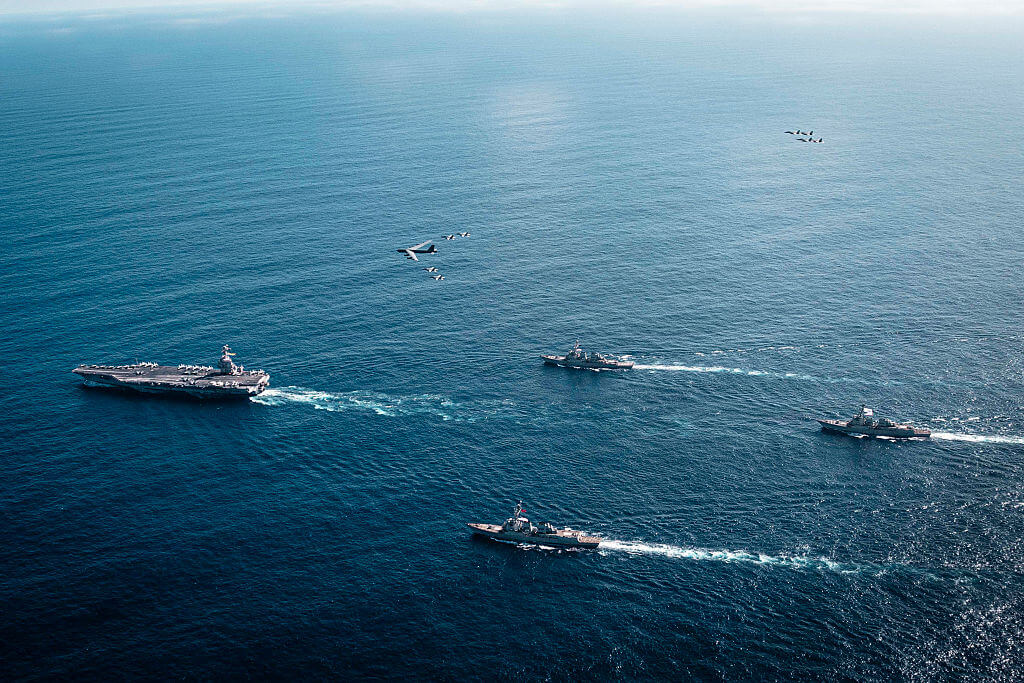 AT SEA- NOVEMBER 13: In this handout provided by the U.S. Navy, The U.S. Navy's Gerald R. Ford Carrier Strike Group, including the flagship USS Gerald R. Ford (CVN 78), left, USS Winston S. Churchill (DDG 81), front, USS Mahan (DDG 72), back, USS Bainbridge (DDG 96), and embarked Carrier Air Wing Eight F/A-18E/F Super Hornets assigned to Strike Fighter Squadrons 31, 37, 87, and 213, operates as a joint, multi-domain force with a U.S. Air Force B-52 Stratofortress, November 13, 2025. U.S. military forces, like the Gerald R. Ford Carrier Strike Group, are deployed in support of the U.S. Southern Command mission, Department of War-directed operations, and the President's priorities to disrupt illicit drug trafficking and protect the homeland. (Photo by Tajh Payne/US Navy via Getty Images)