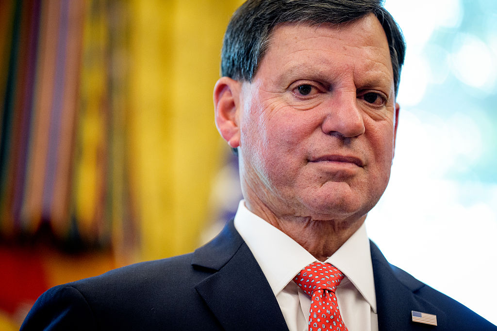 Frank Bisignano (L), Administrator of the Social Security Administration, stands next to U.S. President Donald Trump in the Oval Office of the White House on August 14, 2025 in Washington, DC.