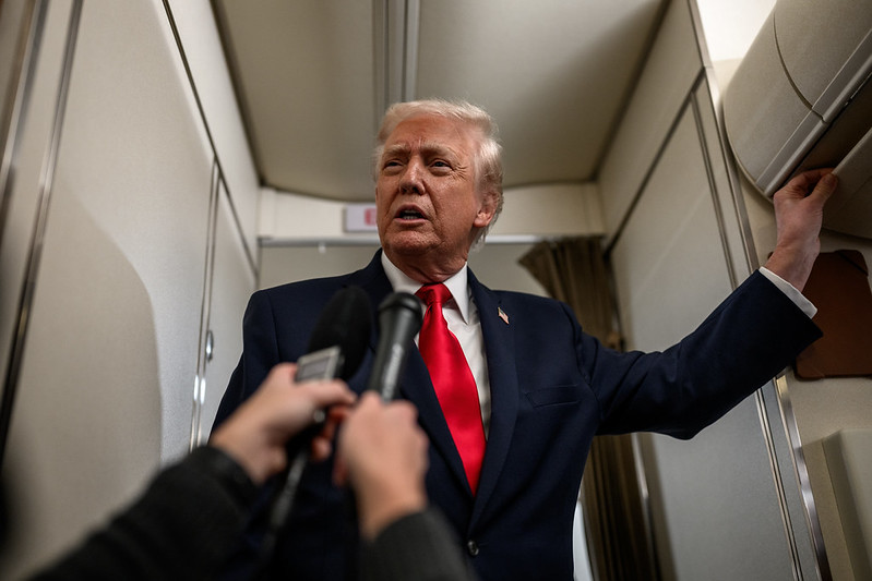 President Donald Trump answers questions from members of the media aboard Air Force One en route to Mount Pocono, Pennsylvania, for a rally on the economy, Tuesday, December 9, 2025.