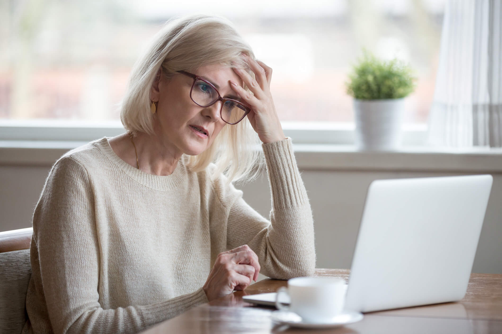 Confused mature woman thinking about online problem looking at l. Thoughtful confused mature business woman concerned thinking about online problem looking at laptop, frustrated worried senior middle aged female reading bad email news, suffering from memory loss