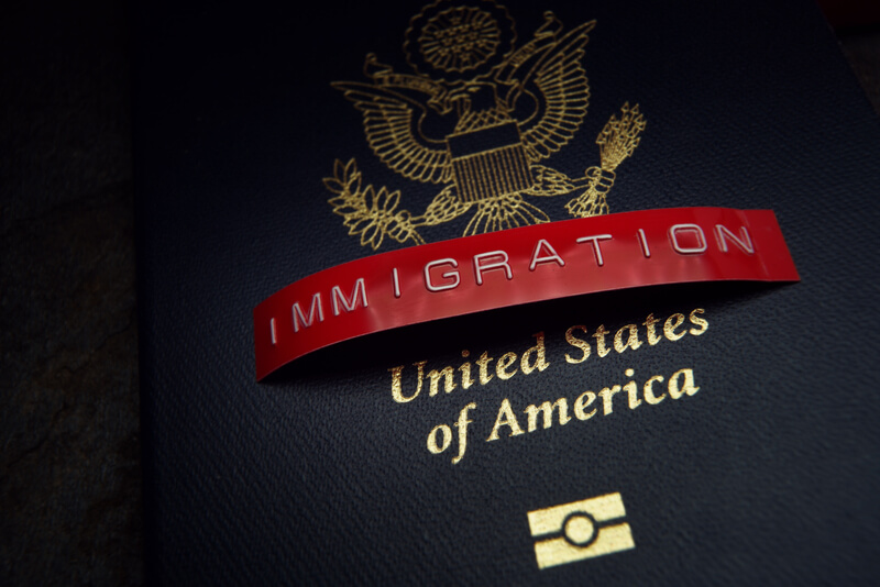 United States passport with red Immigration label.